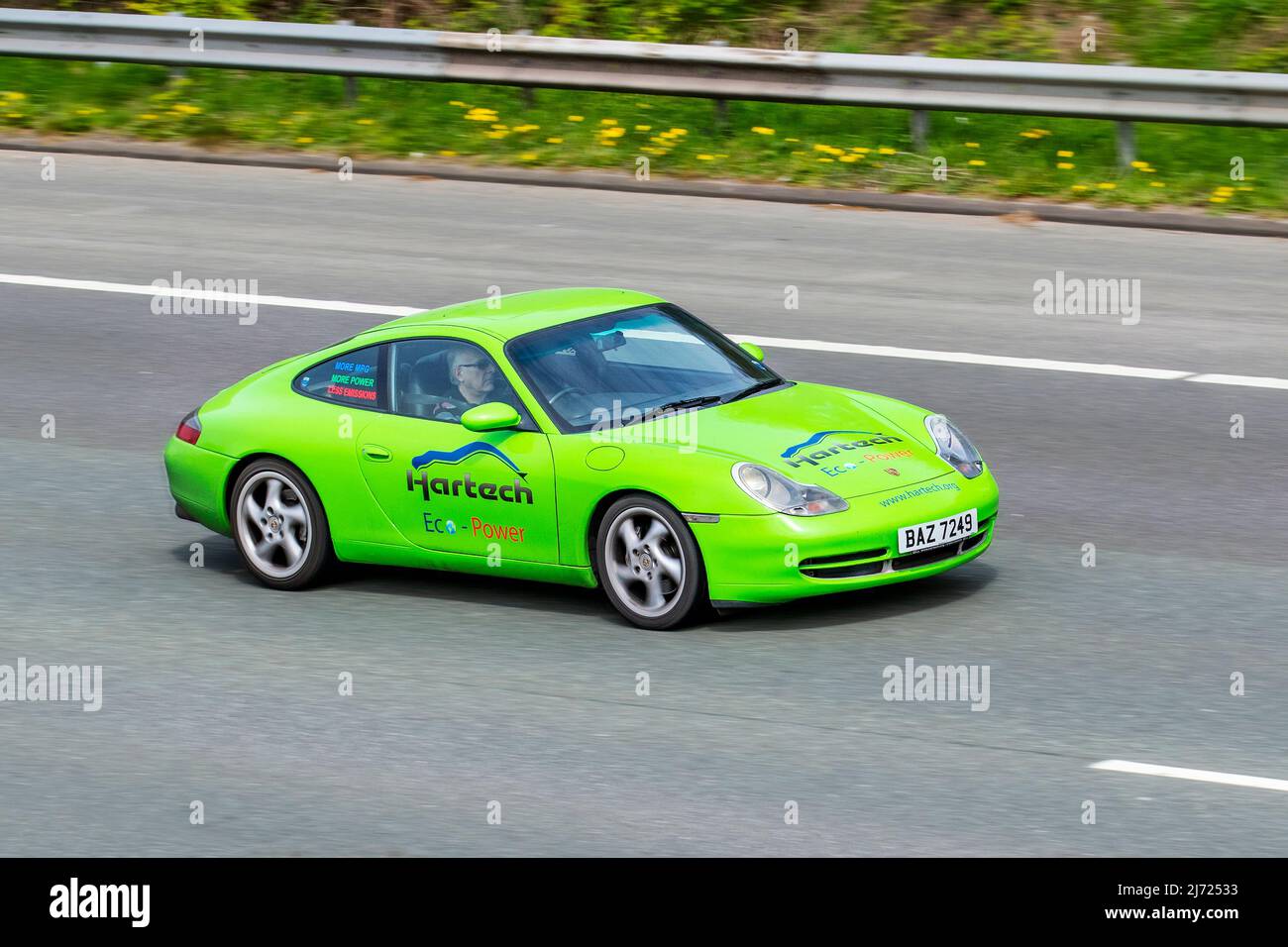 Hartech Eco-Power. Independent Porsche engine specialists. 1999 90s nineties green Porsche Carrera Coupe 3400cc petrol gas 6 speed manual; driving on the M61 motorway UK Stock Photo