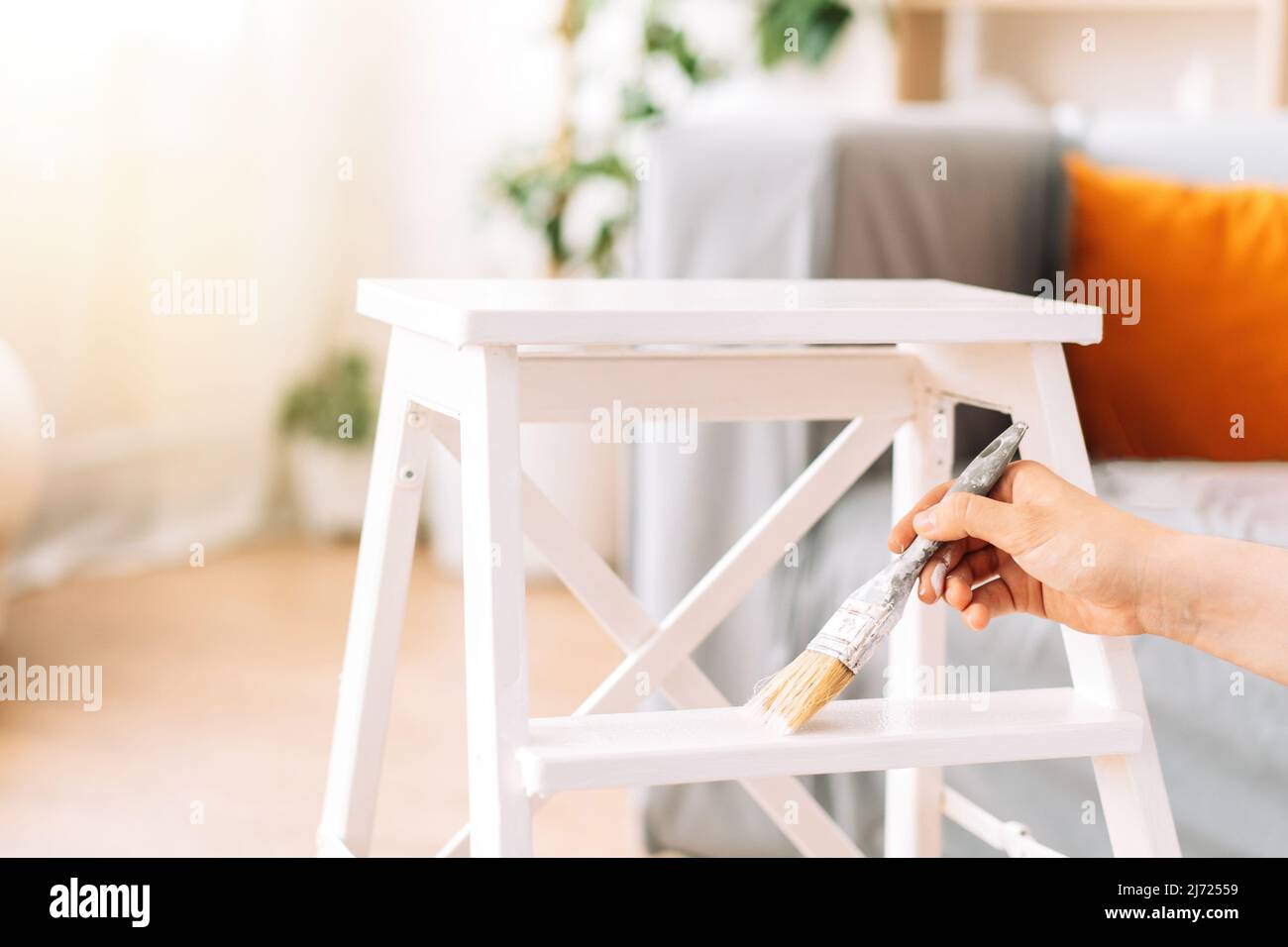Painting wooden chair white colour with brush Stock Photo Alamy