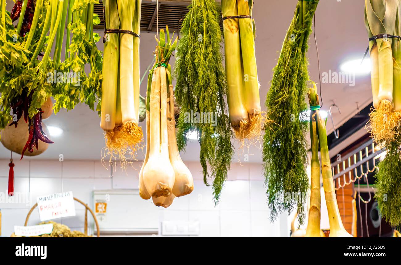 Garlic with long stem hanging, stall at Mercado Triana, Seville, Spain Stock Photo
