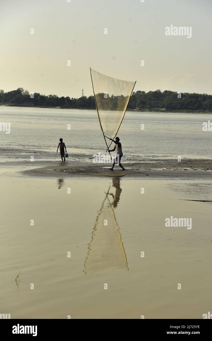 May 5, 2022, Guwahati, Guwahati, India A man carry fishing net in river Brahmaputra to catch