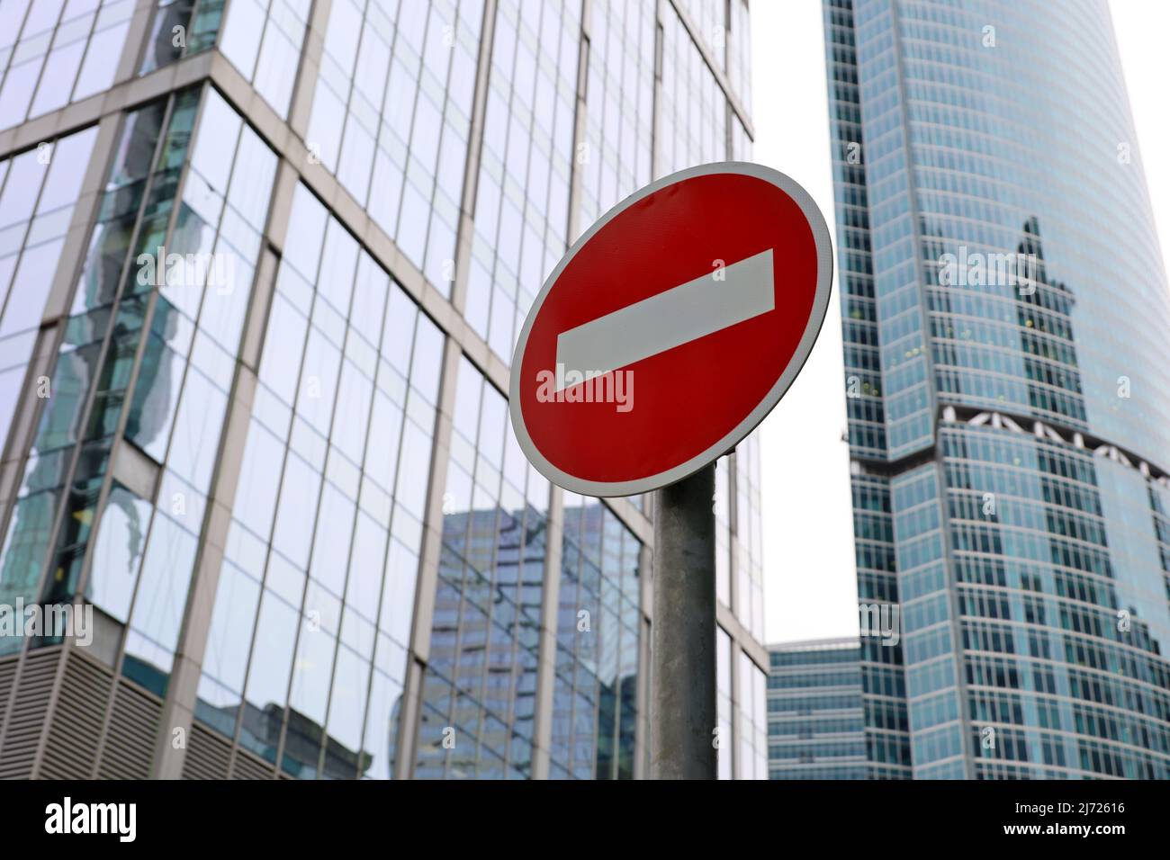 No entry sign on skyscrapers background in downtown. Concept of economic sanctions, financial crisis, global business Stock Photo