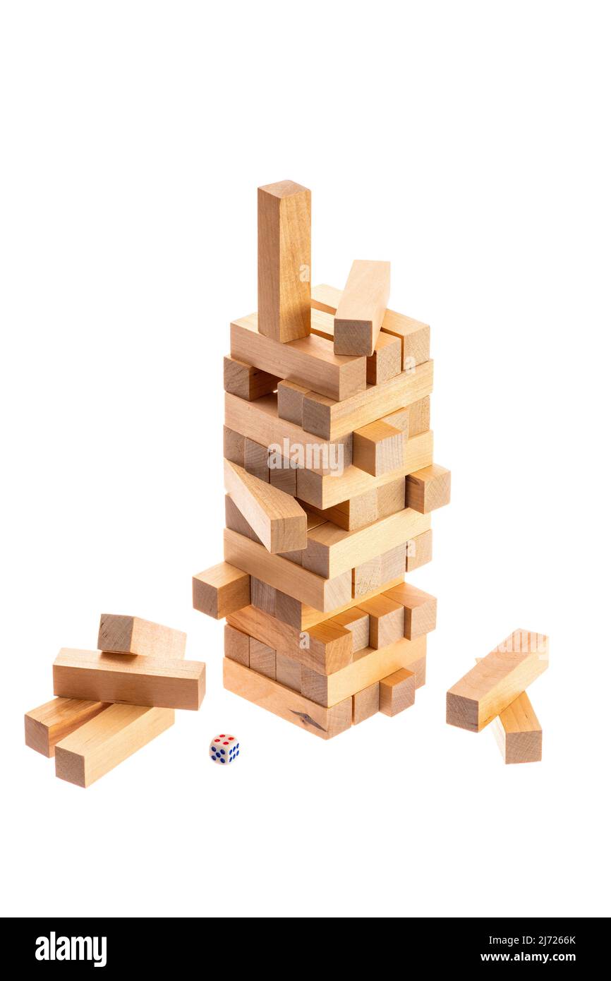 tower made of wooden blocks falling on white background Stock Photo