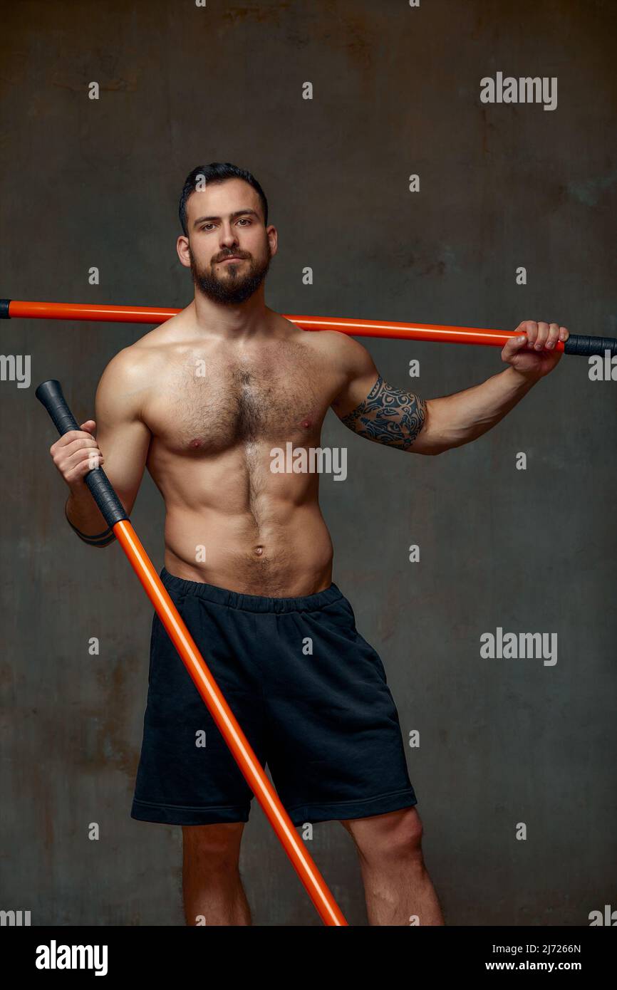 An experienced fighter, stands in a fighting posture with a fighting