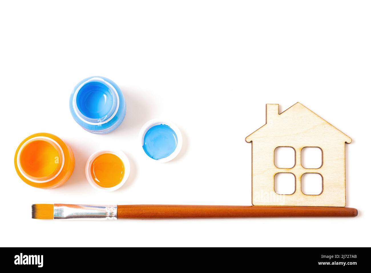 Paint, brush and flat house model isolated on white background