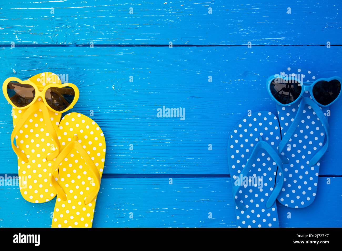Beach flip-flops and sunglasses on blue wooden background. Summer ...