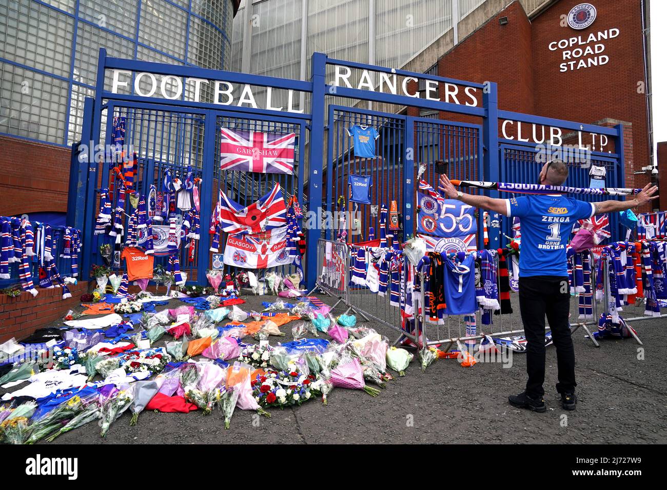 Flowers and keepsakes are placed outside in memory of former Rangers