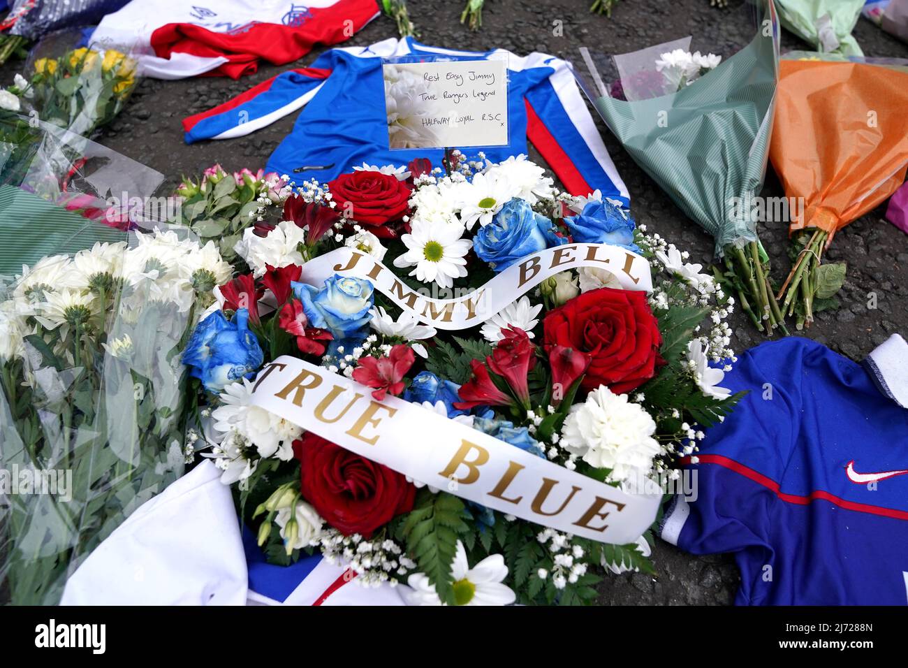Flowers and shirts are placed outside in memory of former Rangers kit