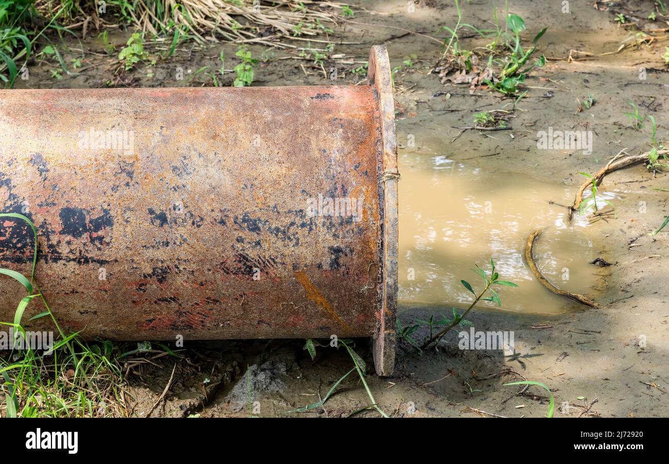 Close up shot of a dredging pipe on a muddy land Stock Photo - Alamy