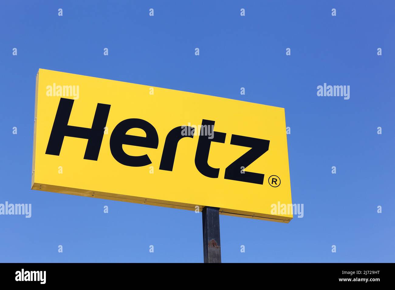 Saint Priest, France - June 18, 2017: Hertz logo on a panel. Hertz is an American car rental company with international locations Stock Photo