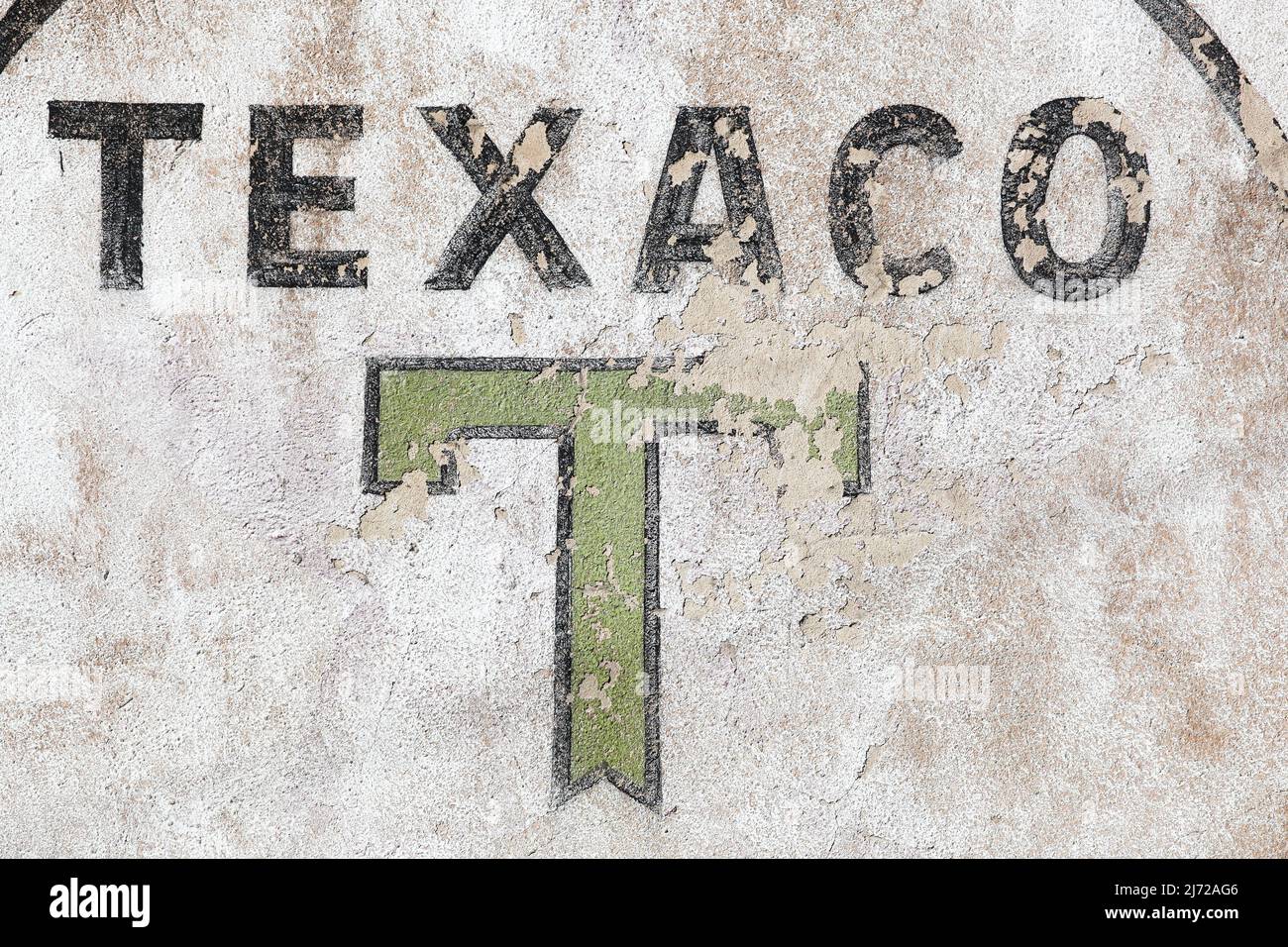 Beaujeu, France - July 8, 2020: Retro Texaco logo on a wall. Texaco is an American oil subsidiary of Chevron Corporation Stock Photo