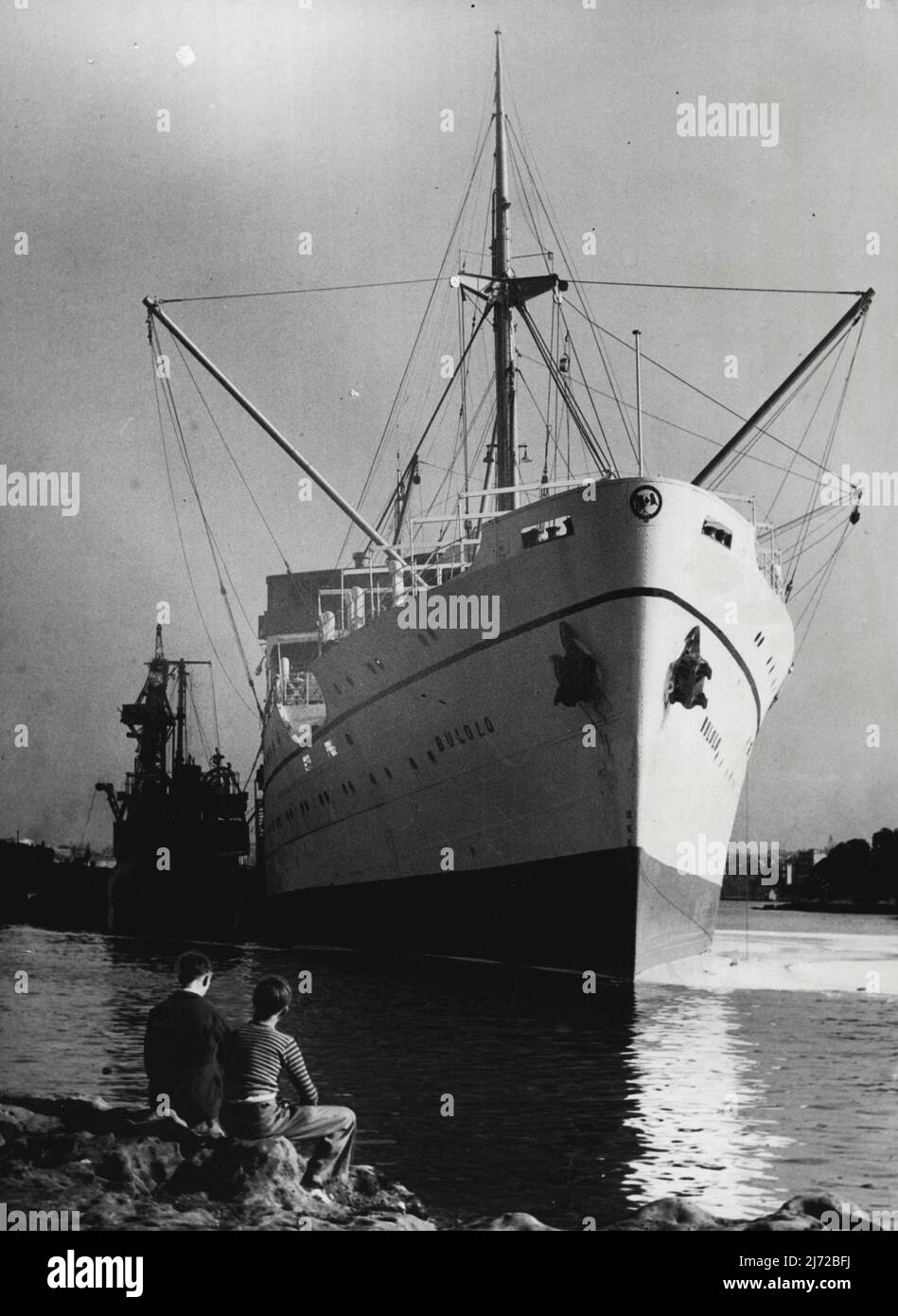 The Burns Phillip liner Bulolo IMN Kerosene Bay today. Left: The Burns Philip liner Bulolo lying upright in shallow water in ***** Wednesday after she began to list alarmingly while firemen were fighting a pontoon floating in 20 feet of water in a *****. August 30, 1951. (Photo by Bert Power/Fairfax Media). Stock Photo