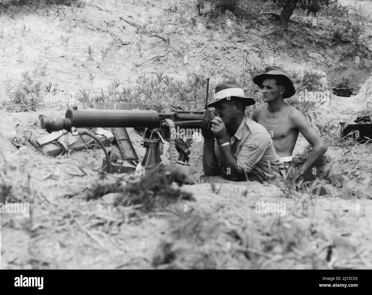 Firing a Vickers Gun from a foxhole during intensive training at Haramura Japan. WOII D. Griffiths of 14 cooper Street Cootamundra NSW and Pte D.R. Woods of Dairy Road Ingleburn NSW. The British Commonwealth Occupation Force in Japan is being raised to war time strength and 3 Bn Royal Australian Regiment has been training intensively for the type of terrain which will have to be covered in Korea. September 13, 1950. (Photo by Public Relations Section, HQ BCOF). Stock Photo