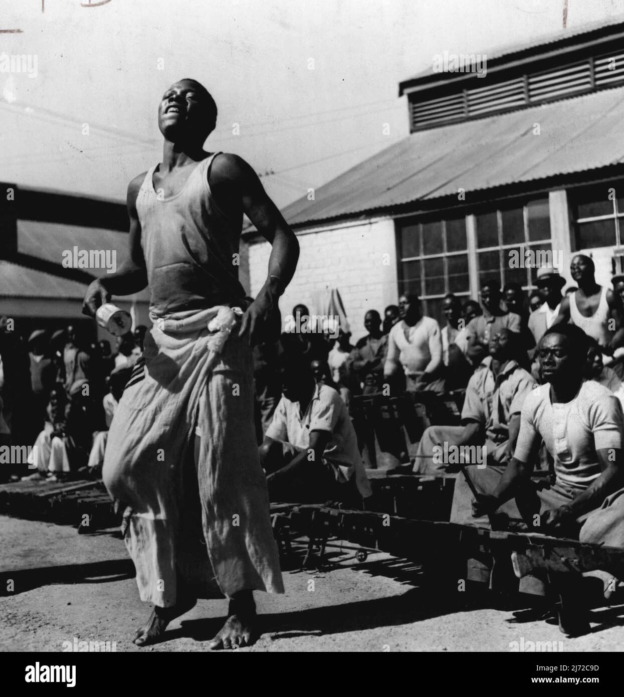 'Look Out For Natives' - Skin - Deep Civilization In Johannesburg, South Africa - Young Zulu gold miners staging dance in their compound. Tomtons beat as they chant the opening strains. March 14, 1938. (Photo by Pix Publishing Inc.). Stock Photo