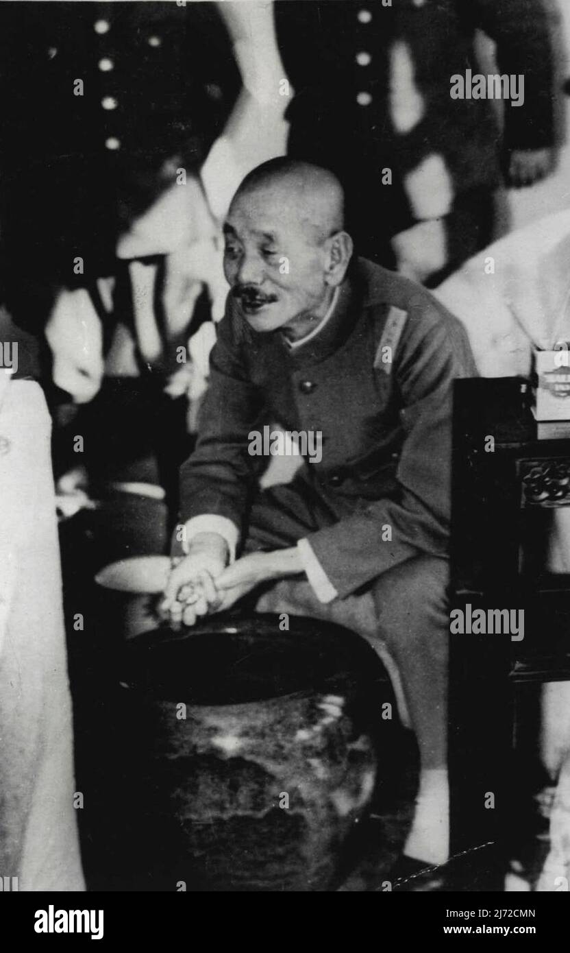 Japanese Commander-In-Chief Gives An Interview -- An excusive and intimate close up of Japan's commander-on-Chief of Military forced in Shanghai, who directed the ***** on Nanking-General Iwane Matsui, taken at ***** Headquarters curing an interview with newspaper men on the picture of China. During the interview he smoked Japanese cigarettes, had his leather puttees off revealing heavy ***** and were Chinese rubber soled slippers. For heating, he used around porcelain bowl filled with *****. January 1, 1938. (Photo by Keystone). Stock Photo