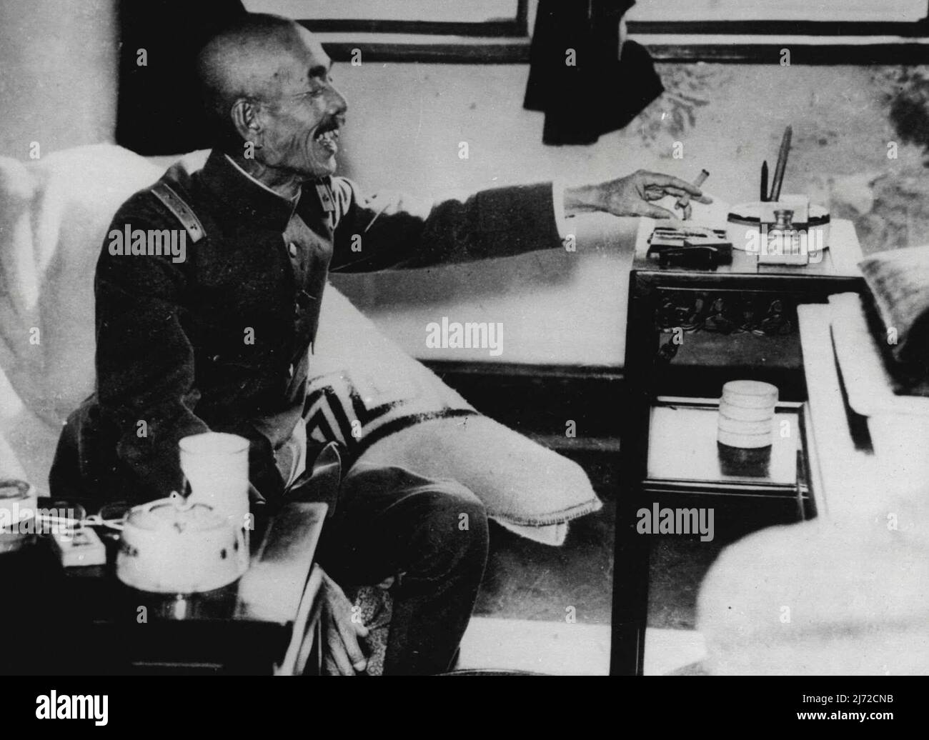 ** Mind Of Nippon In ***** Mood -- The man behind the Japanese guns which caused the ***** the Chinese capital was General Iwane Matsui commander in Chief of the military. The General is ***** a cigarette and a joke while he was being interviews newspapermen at his Shanghai headquarters. February 1, 1938. (Photo by keystone). Stock Photo