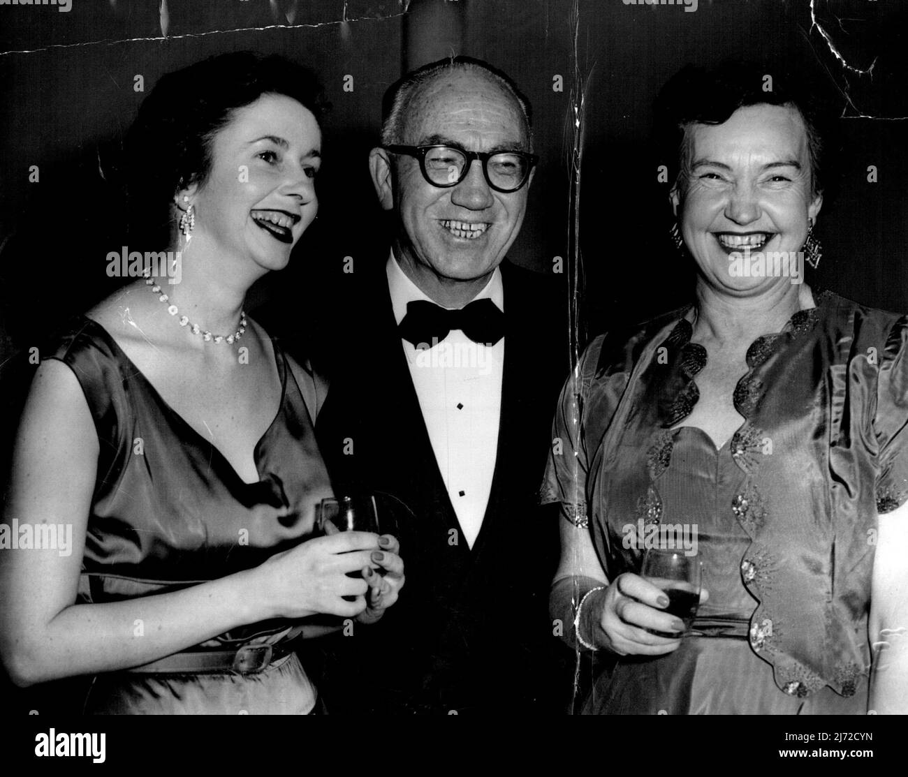 Miss Jill Maher, Mr. F. Meere and Mrs. Madge Fox at Trade and customs Ball. June 30, 1955. (Photo by Kenneth Charles Redshaw/Fairfax Media). Stock Photo