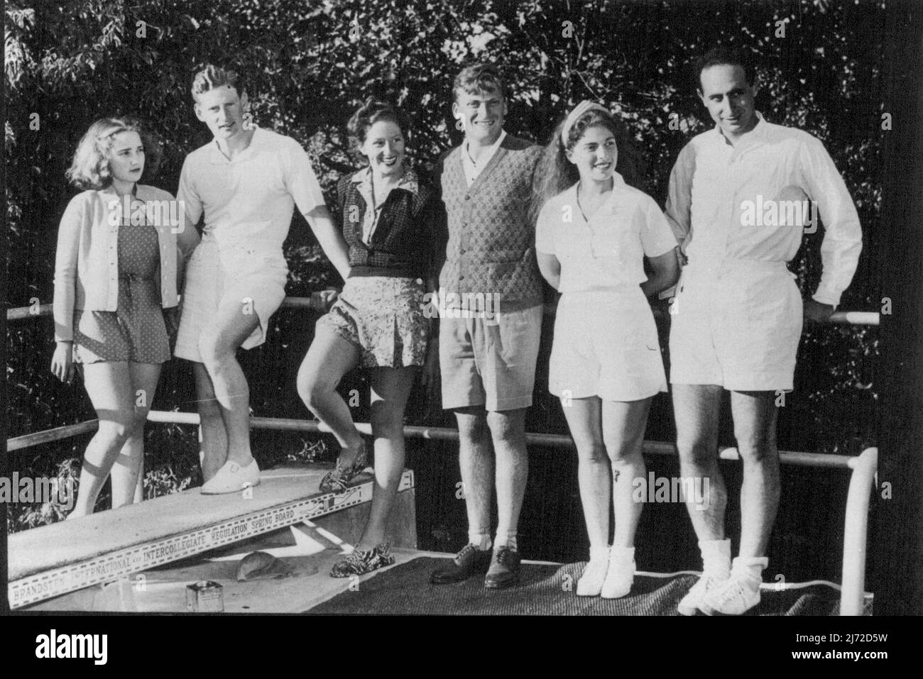 An exclusive photograph of the three Menuhin whose marriage romance stirred the world swimming pool on the Menuhin Estate at Los Gatos, California. Yehudi Menuhin the world famous violinist, who was married in London last May is returning to give two concerts in London in the Spring, and will tour the provinces. Left to right, Yehudi's sister Hephzibah (now Mrs. Lindsay Nicholas), Mr. Lindsay Nicholas - (Hepzibah's husband) Nola, wife of Yehudi Menuhin who is sister of Lindsay Nicholas), Menuhin, Yaltah ***** William Strix) sister of ***** husband Mr. Willam. December 31, 1938. Stock Photo