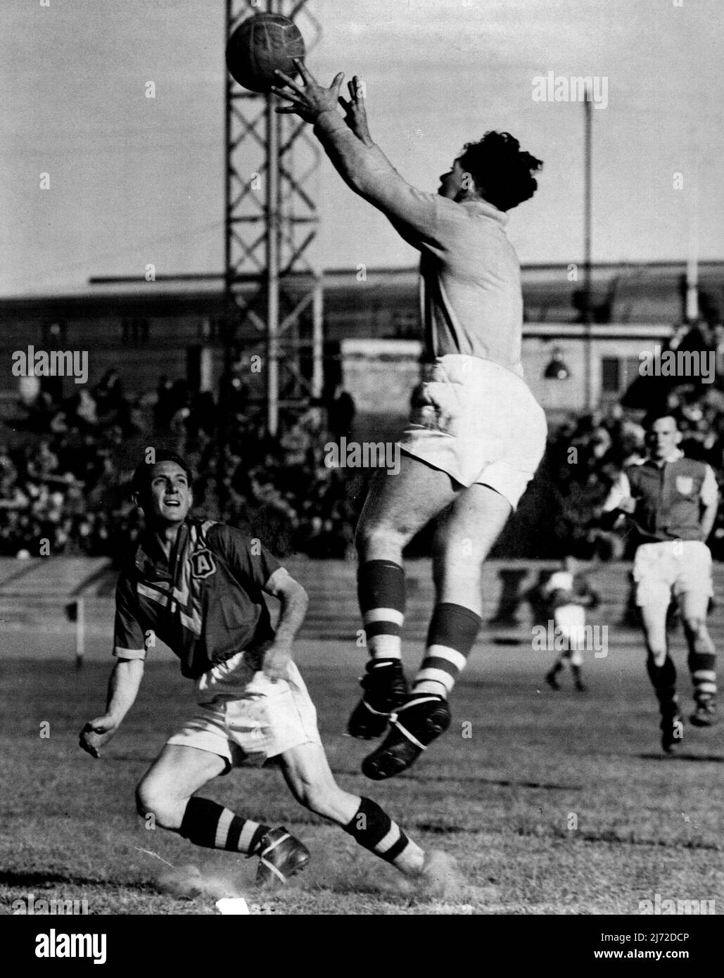 Ron Lord leaps high to make a save. He's a real find. September 5, 1950. Stock Photo