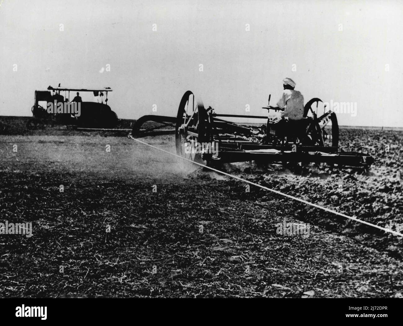 Deal On The Nile. The Gezira Cotton Scheme -- Large scale ploughing of more difficult soil is done by big ***** ploughs Engines stationed either end of huge fields draw plough back ***** and forwards on cables between them. This method is found more economical ***** efficient than use of tractors. Machines are from pool maintained by cotton company. British Government in Africa has long had its own 'Tennessee Valley' scheme - Gezira Cotton Scheme in the valley area of nearly a million acres between the ***** and white Niles. Plans for the area's development were begun before tee last ***** and Stock Photo
