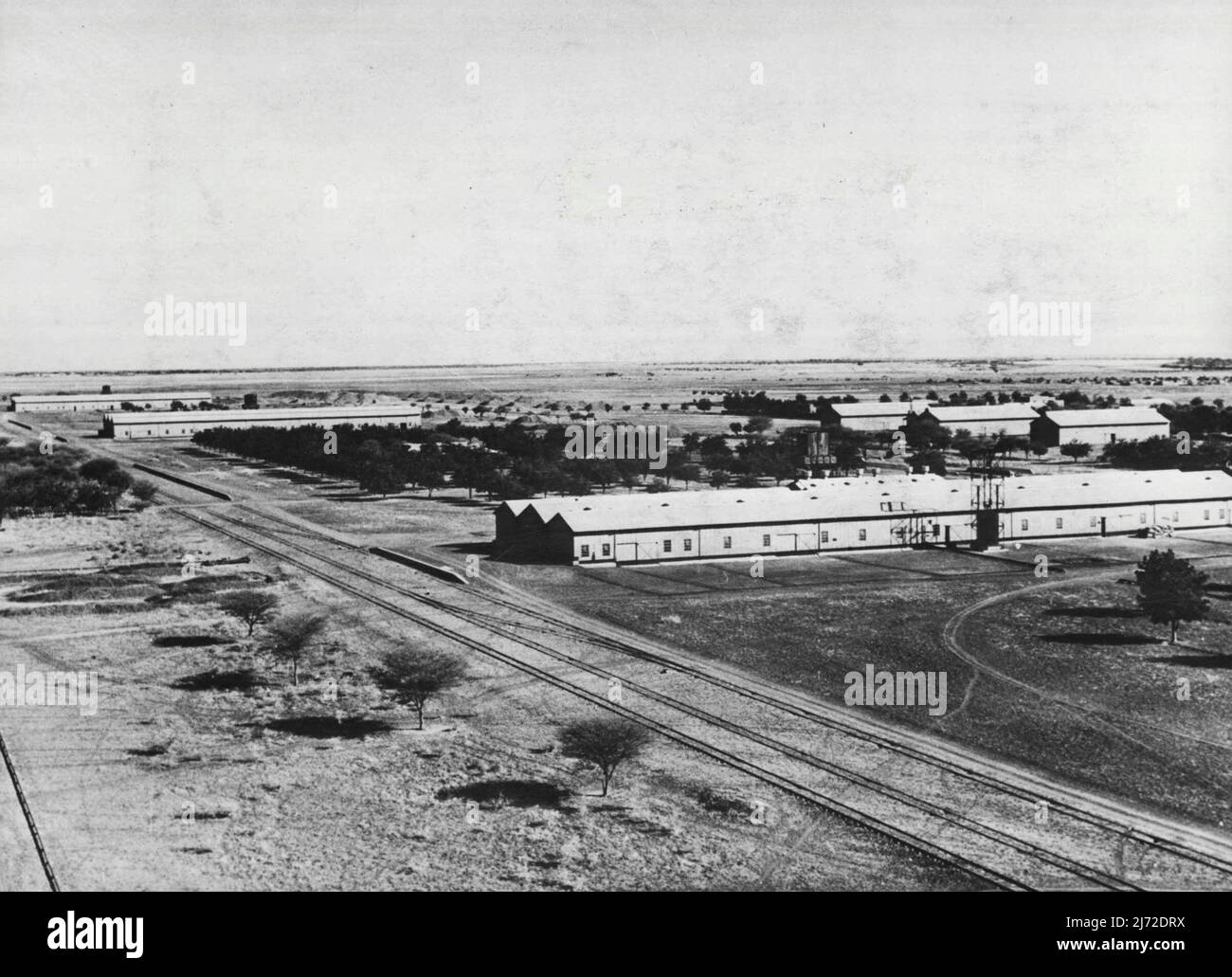 New Deal On The Nile. The Gezira Cotton Scheme -- Headquarters of Sudan Cotton Syndicate with three large ginning factories and other buildings covers wide area near Wad Madani. In foreground is a line of Sudan Government Railways which takes cotton to Port Sudan for export. The British Government in Africa has long had its own 'Tennessee Valley' scheme the Gezira Cotton Scheme in the Valley area of nearly a million acres between the Blue and White Niles. Plans for the area's development were begun before the last war, and by 1925 the Sennar Dam, two miles long and over a hundred foot high at Stock Photo