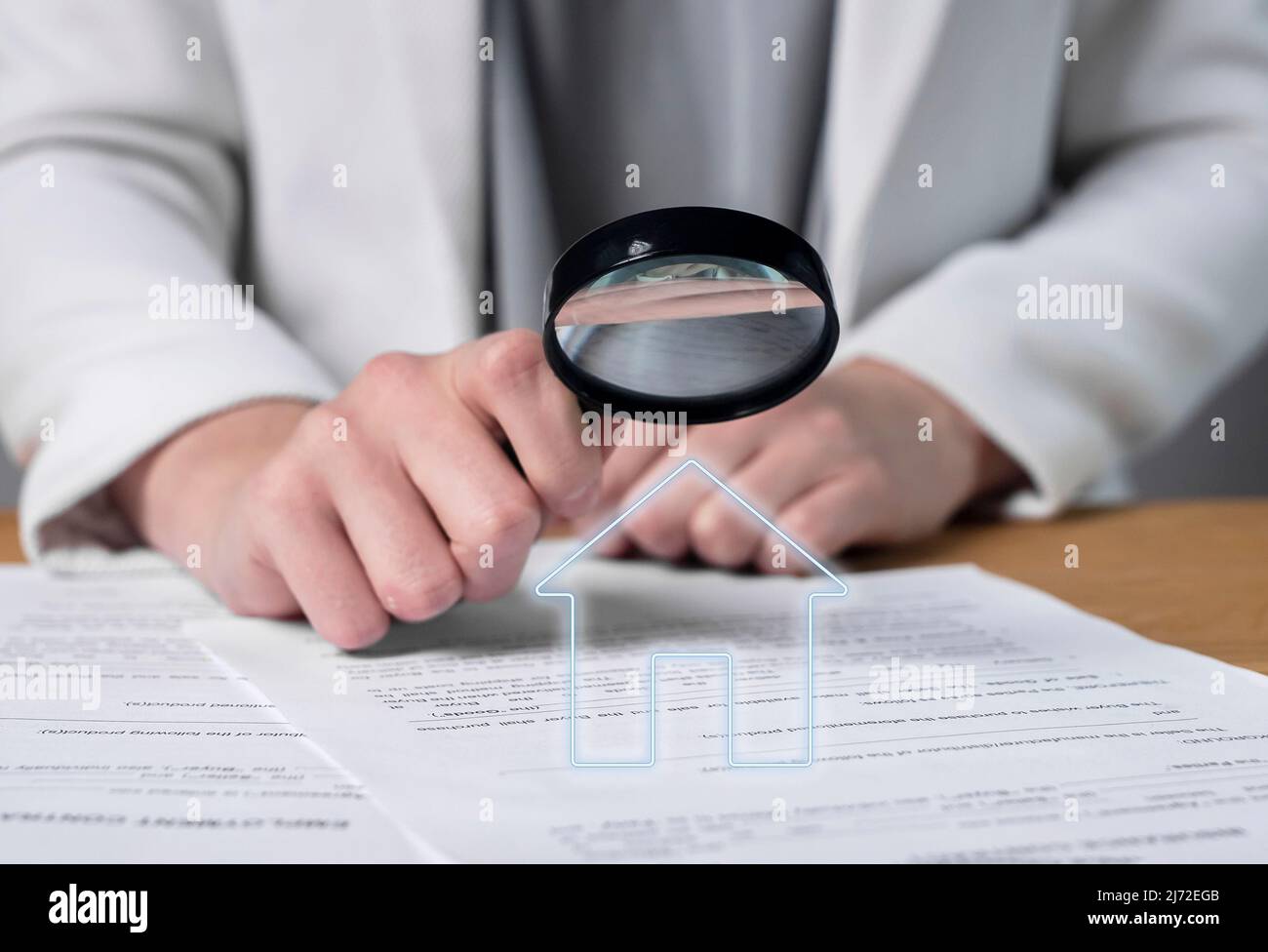 Woman hands holding magnifier and studying real estate purchase, lease or home loan agreement. Thorough analysis of contract terms and conditions. Apartment or house buying or sale. High quality photo Stock Photo