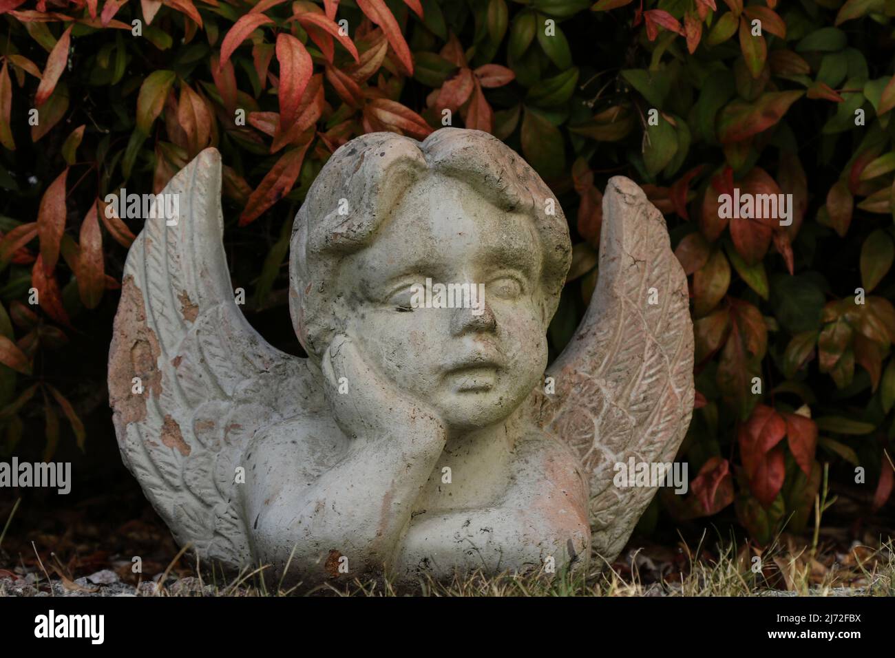 Close up of a white angel. Moment of grief at the end of a life. Last farewell. Funeral concept. Stock Photo