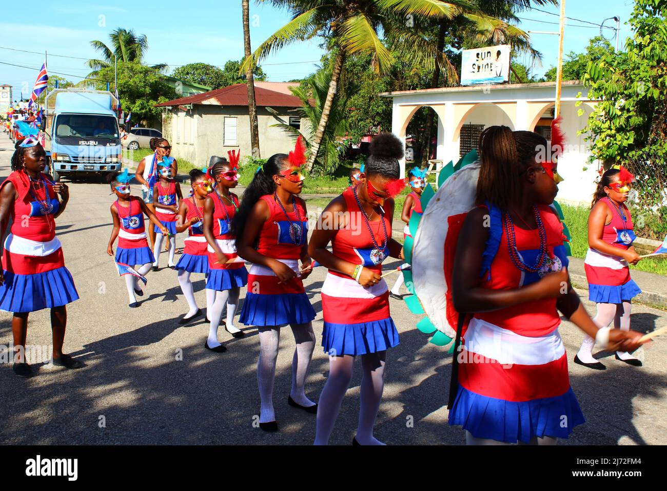 PUNTA GORDA, BELIZE - SEPTEMBER 10, 2015 St. George’s Caye Day celebrations and carnival dancers with red, white and blue costumes walking Stock Photo