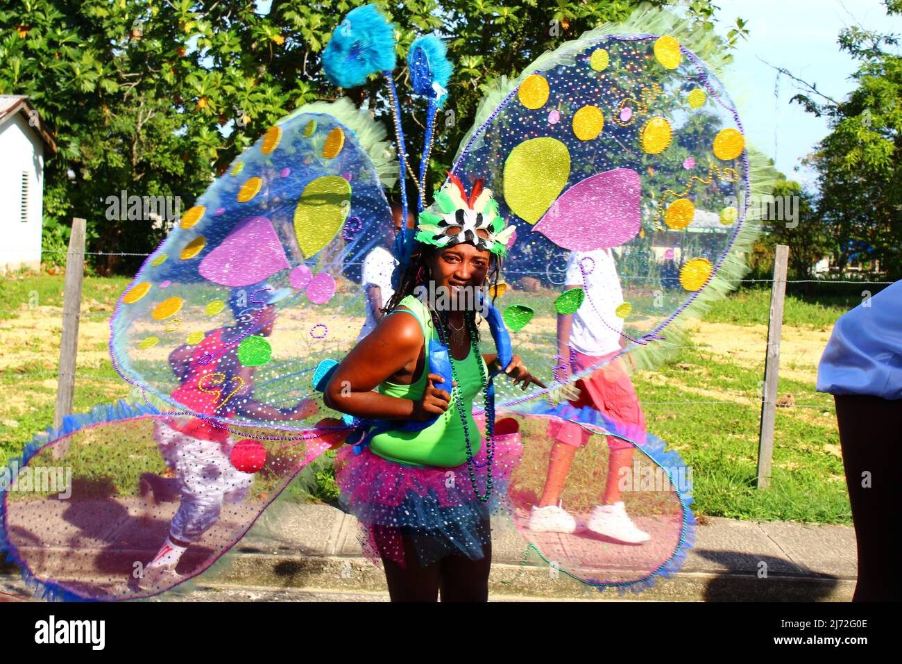 PUNTA GORDA, BELIZE - SEPTEMBER 10, 2015 St. George’s Caye Day celebrations and carnival multicoloured lead dancer with green grass in the background Stock Photo