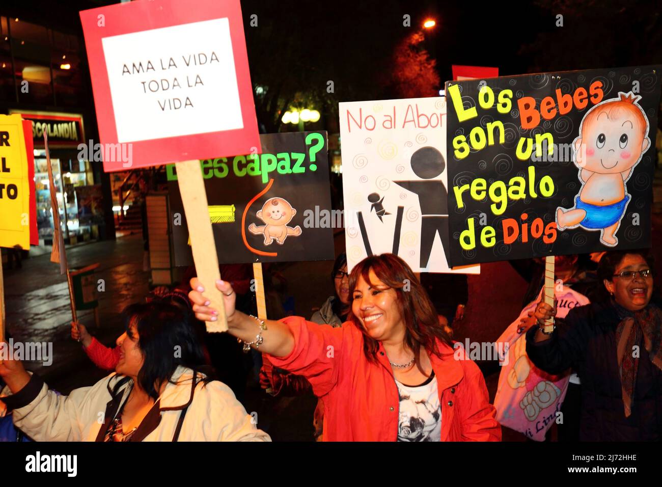 LA PAZ, BOLIVIA, 22nd August 2013. People holding placards with slogans in Spanish take part in a march organised by the Red Pro-Vida (Pro Life Network) to protest against decriminalising abortion. Bolivia has been debating whether to decriminalise abortion since March 2012. Stock Photo