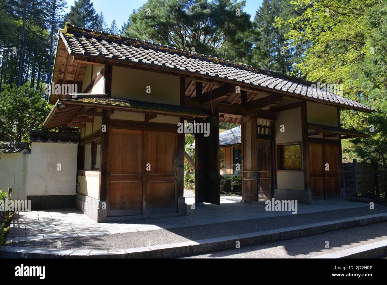 A traditional style gate entrance at the Portland Japanese Garden in spring. Oregon, USA Stock Photo