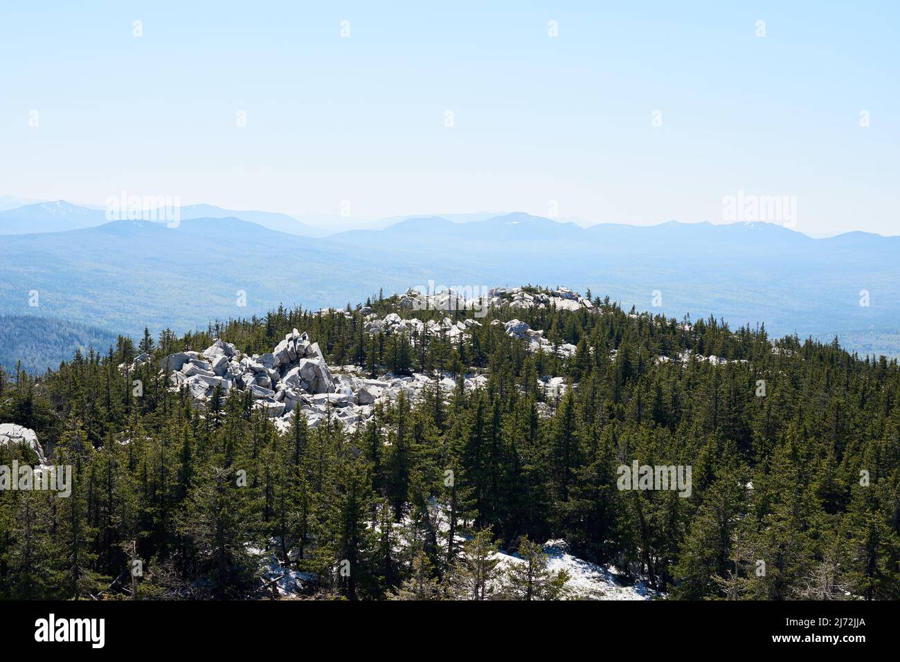 Aerial image of white massive rocks surrounded by conifer woods and ...
