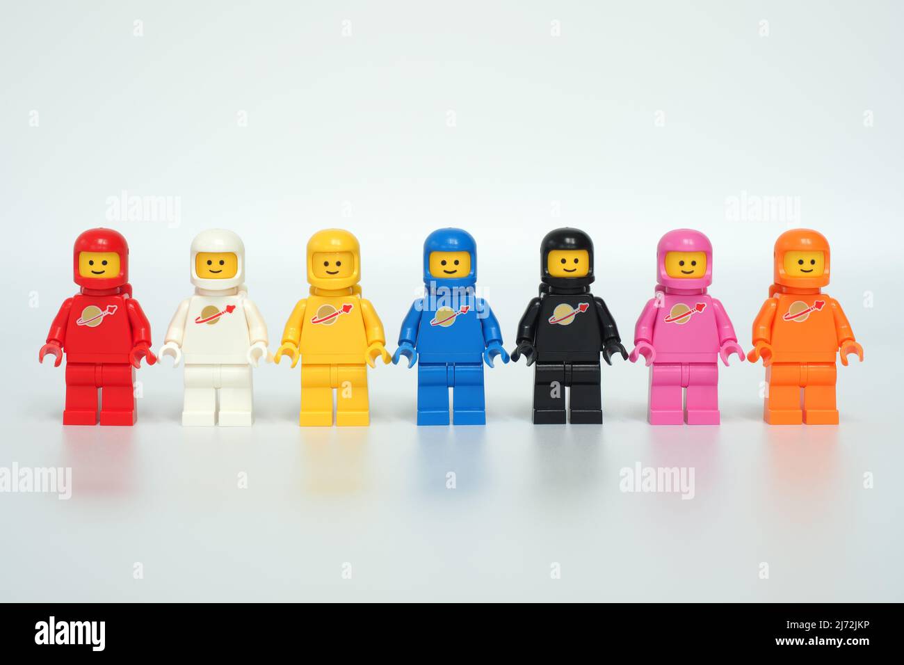 44MP size HRS. Lego Classic Space mini figures. Red & white introduced in 1978, yellow in 1979, blue & black in 1984, pink in 2019 & orange in 2020. Stock Photo