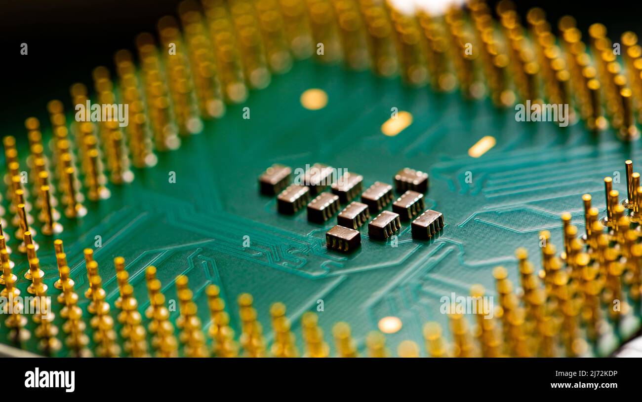 Macro Close up of microchips and pins on Main CPU PC processor circuit board. Stock Photo