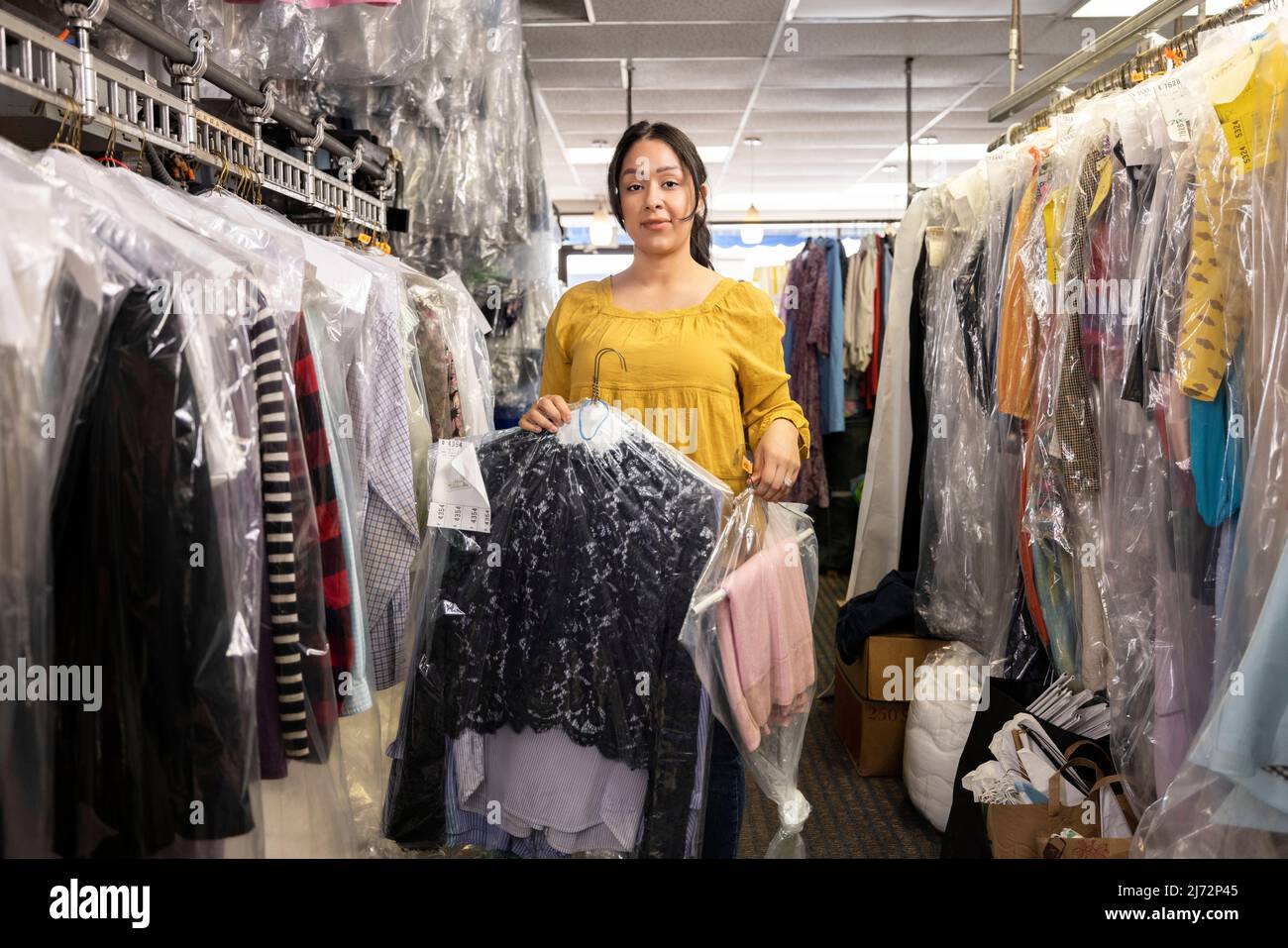 Portrait of a young woman working in a cleaners Stock Photo