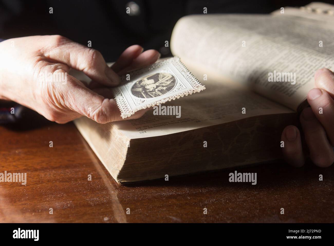 An old woman is looking at an old photo Stock Photo