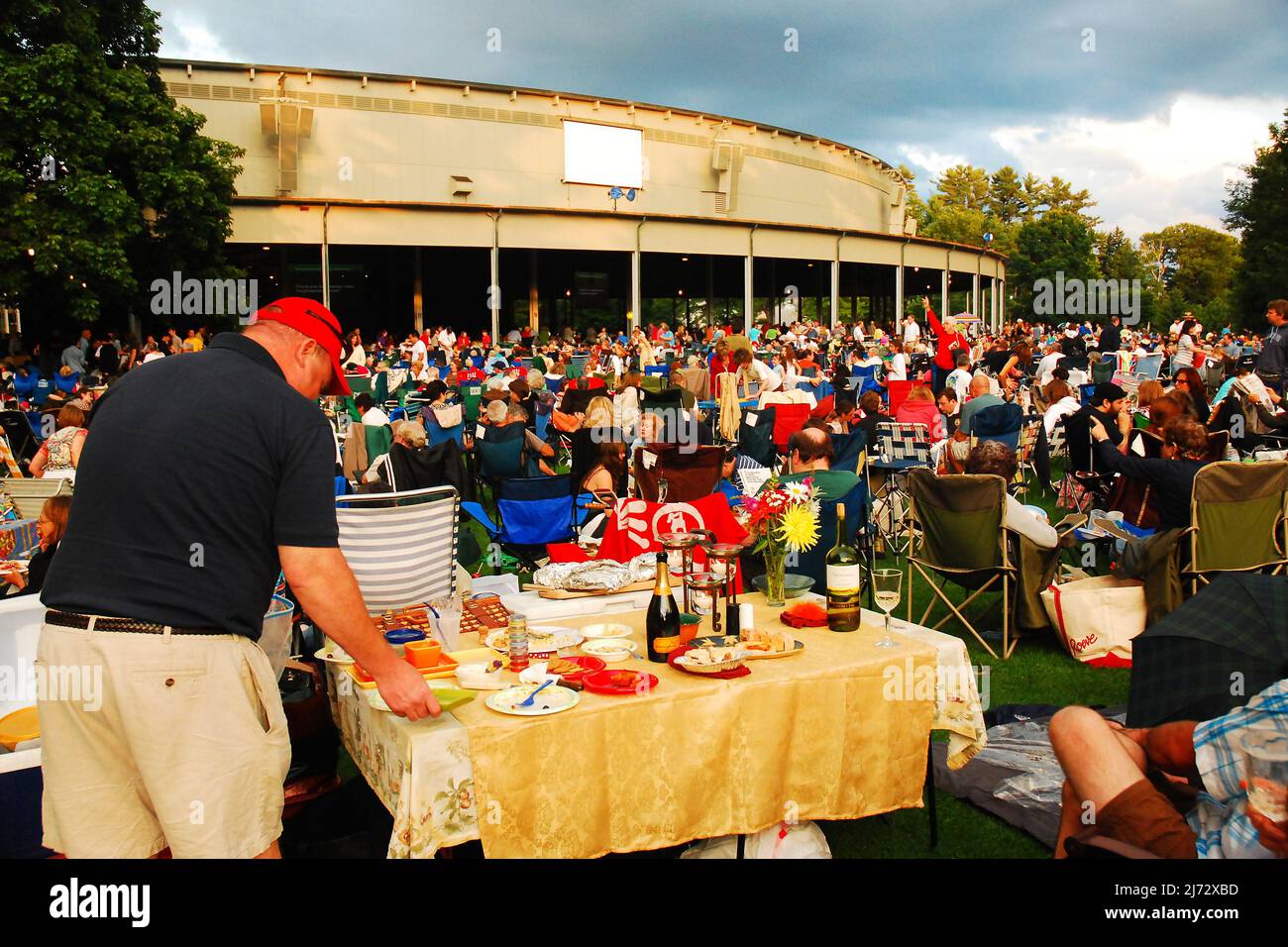 Folks set up a picnic table for fine dining just prior to a concert at