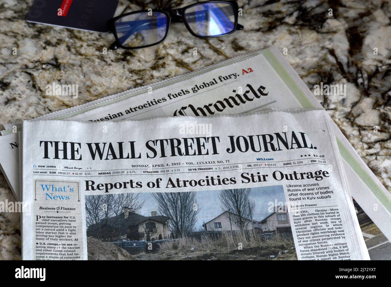A copy of The Wall Street Journal with a headline regarding reports of atrocities in Ukraine by Russian military lies on a hotel bed in San Francisco. Stock Photo