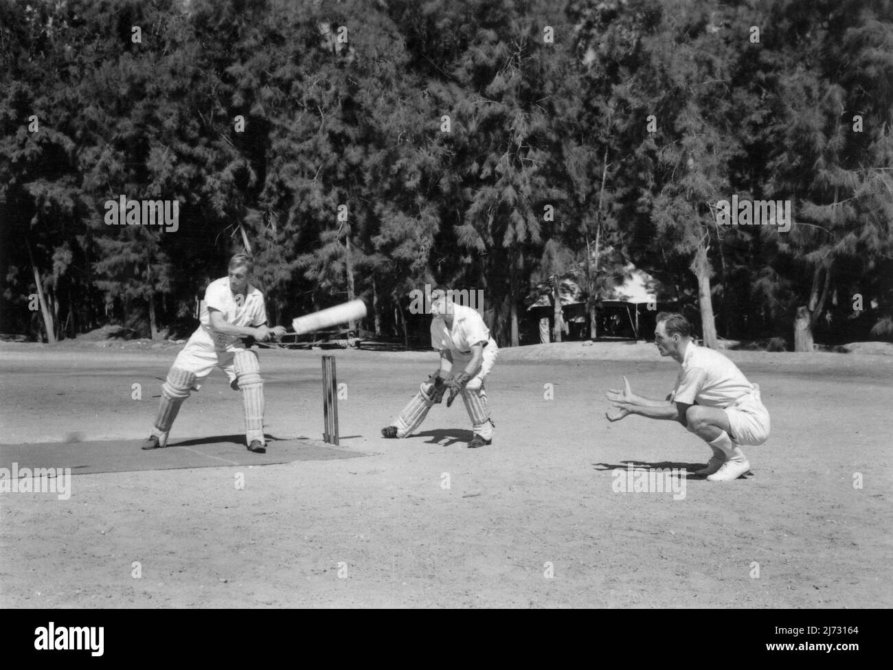 Military servicemen playing cricket on the sports ground at Timsah Rest Camp, Ismailia, Egypt. c.1950. This camp offered rest and recreation for British soldiers garrisoned at bases in the Suez Canal Zone. Stock Photo