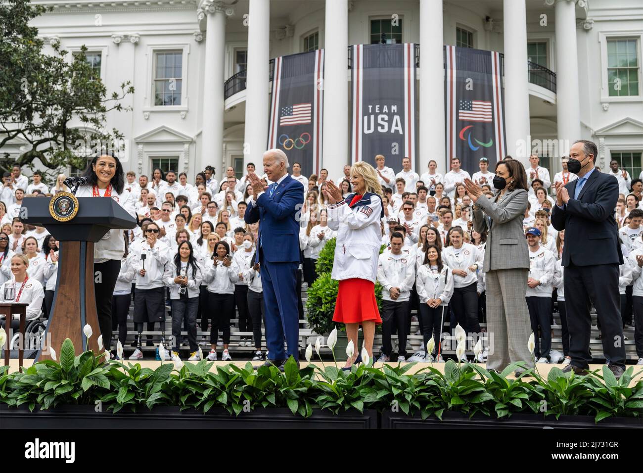 Washington, United States of America. 04 May, 2022. U.S President Joe Biden applauds U.S. Olympic team bobsled medalist Elana Meyers Taylor during an event welcoming the athletes that participated in the Tokyo 2020 Summer Olympic and Paralympics, Beijing 2022 Winter Olympic and Paralympics, on the South Lawn of the White House, May 4, 2022 in Washington, D.C.  Credit: Adam Schultz/White House Photo/Alamy Live News Stock Photo