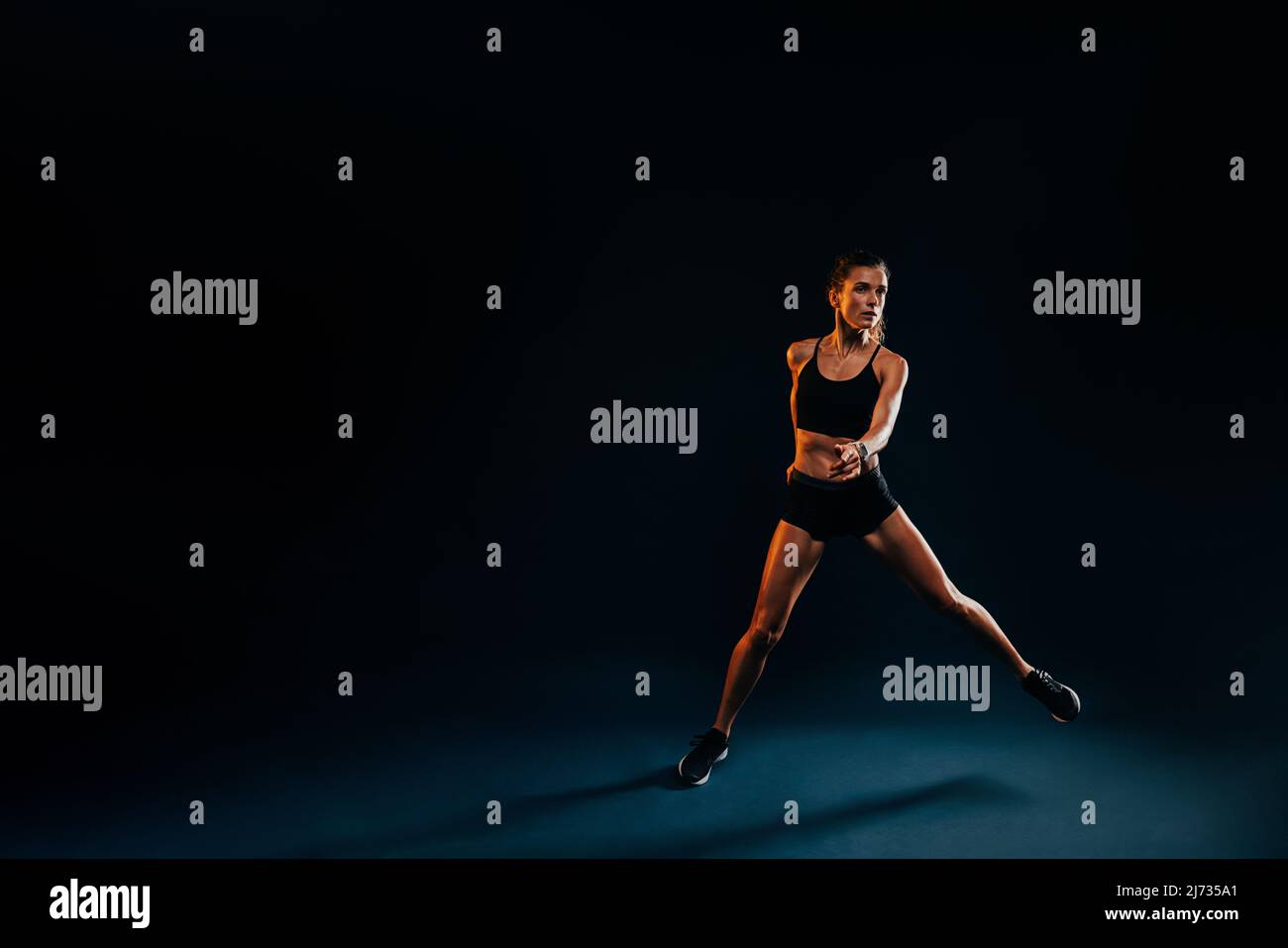 Black woman warming up jumping hi-res stock photography and images - Alamy