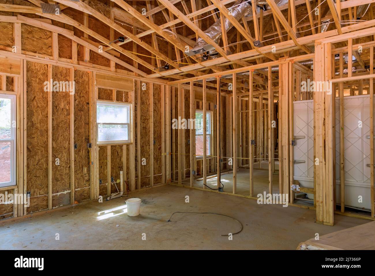 Timber frame house stick built home under construction new build with wooden truss, beam framework Stock Photo