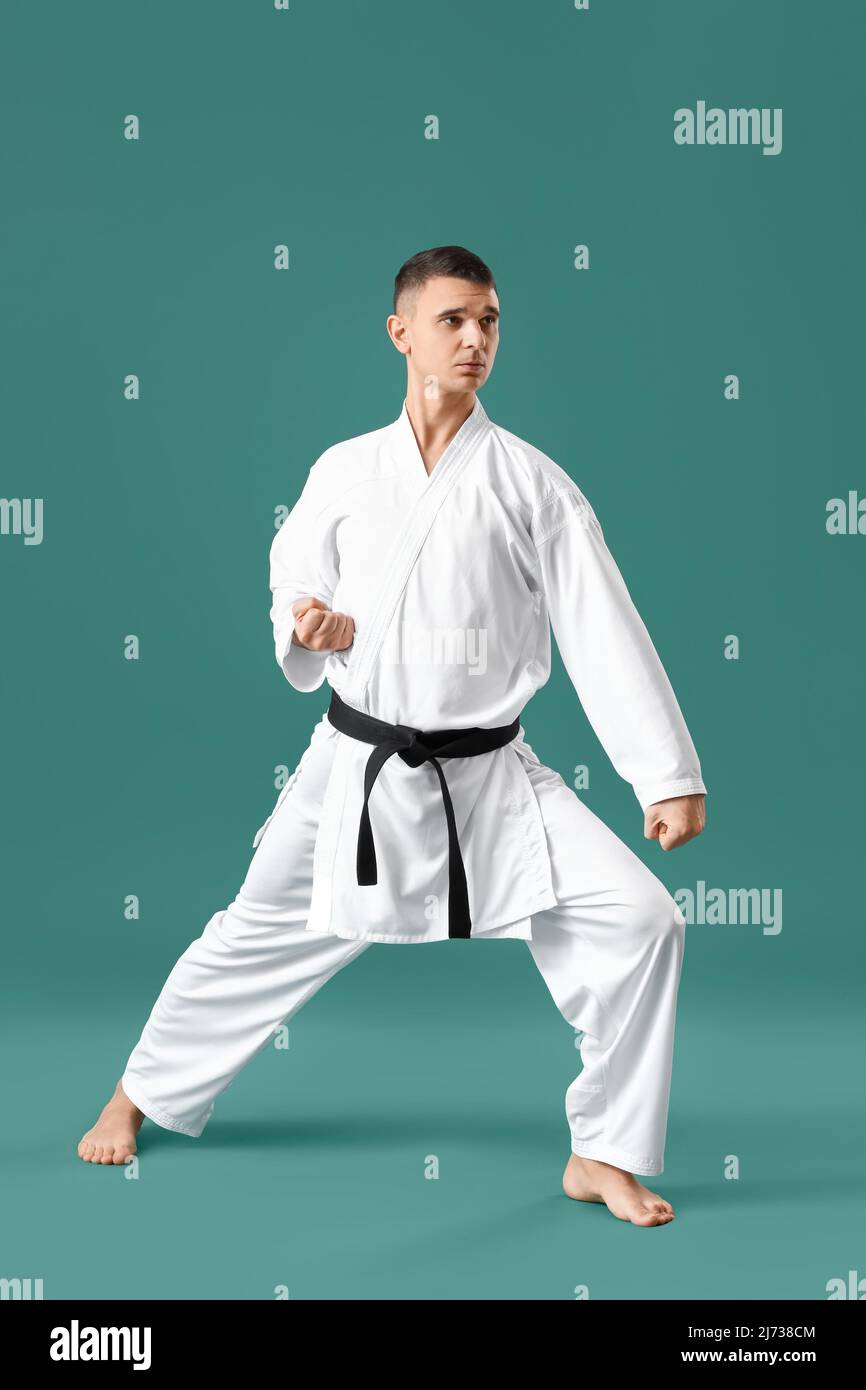 Man practicing karate on green background Stock Photo - Alamy