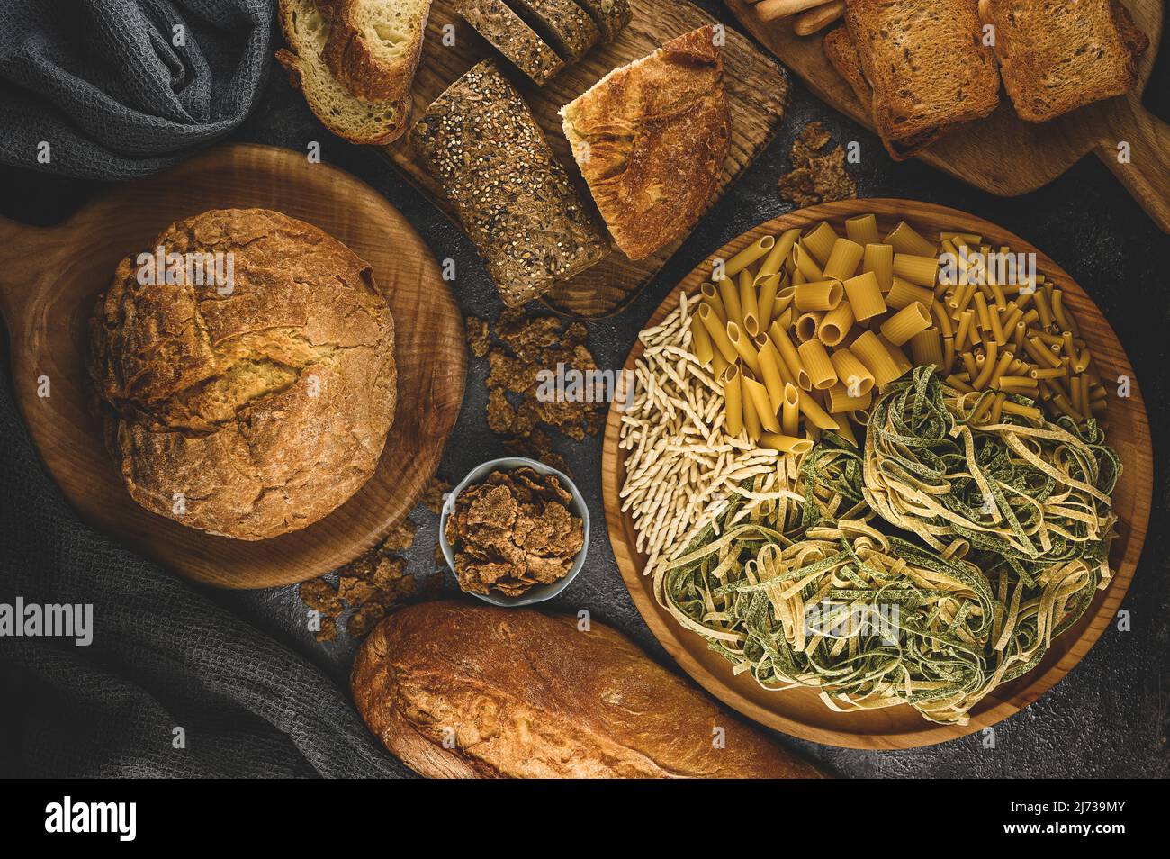 food of pasta, cereals bread. Foods high in carbohydrate. Top view on healthy gluten free bread, pasta on a wooden cutting board. top view. Stock Photo