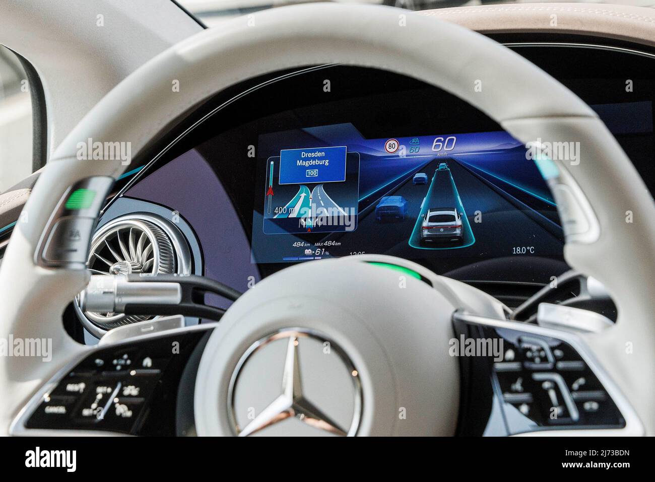 05 May 2022, Berlin: The steering wheel in a moving Mercedes of the ...