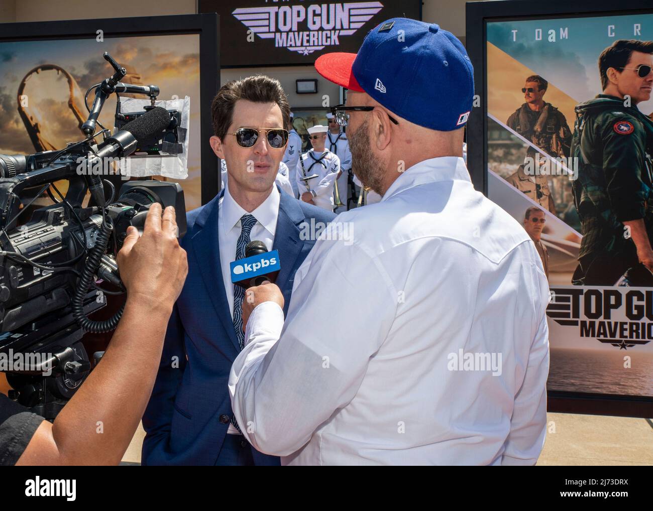 San Diego, United States. 04 May, 2022. Movie director Joe Kosinski, center, is interviewed on the red carpet during the advance movie premiere of Top Gun: Maverick, at Naval Air Station North Island, May 4, 2022 in San Diego, California, Top Gun: Maverick, is the sequel to the 1986 blockbuster, Top Gun and will be released worldwide on May 27.  Credit: MC2 Keenan Daniels/US Navy/Alamy Live News Stock Photo