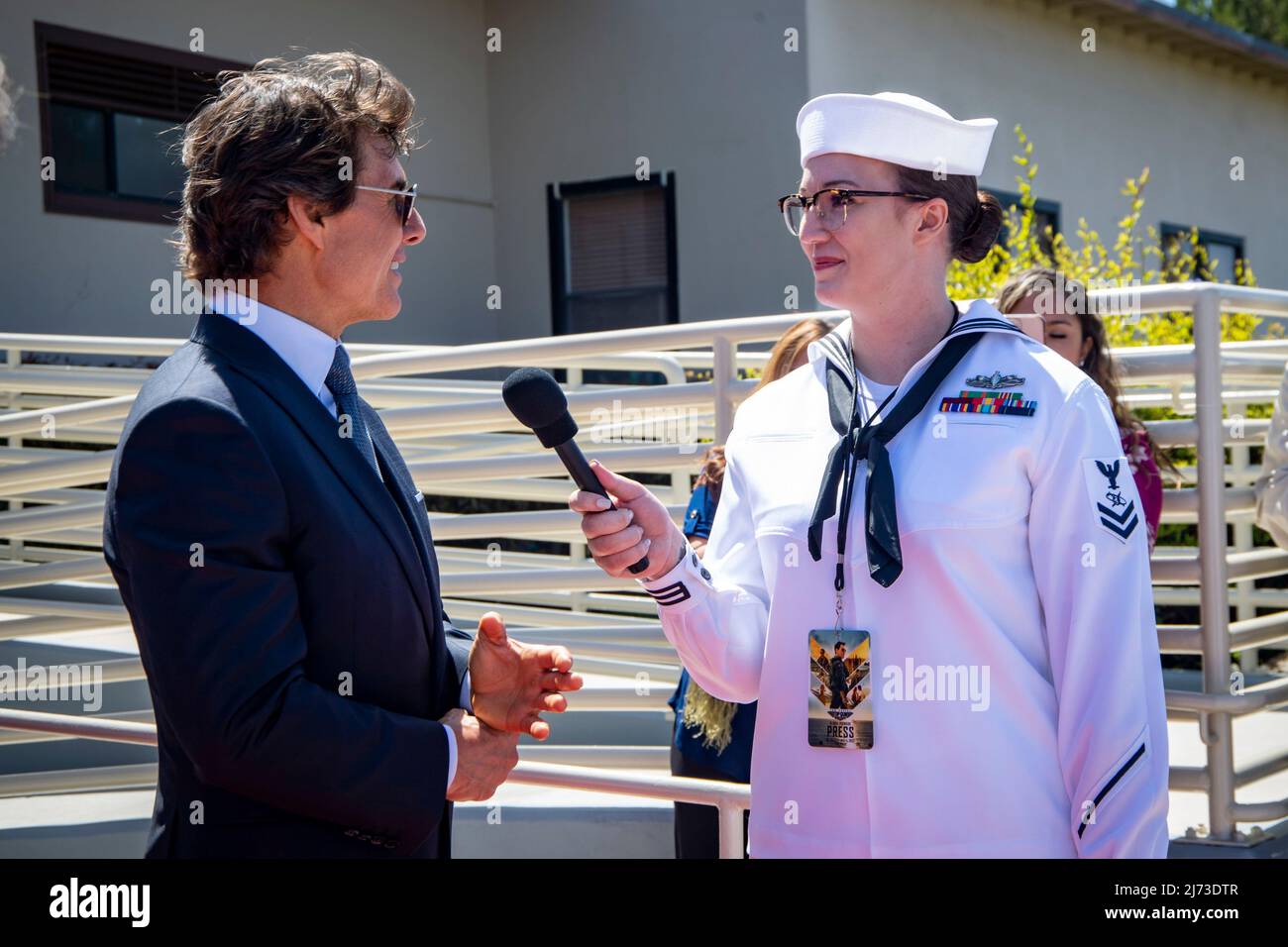 San Diego, United States. 04 May, 2022. American actor Tom Cruise is interviewed by U.S. Navy sailor Chelsea Meiller, right, on the red carpet during the advance movie premiere of Top Gun: Maverick, at Naval Air Station North Island, May 4, 2022 in San Diego, California, Top Gun: Maverick, is the sequel to the 1986 blockbuster, Top Gun and will be released worldwide on May 27.  Credit: MC2 Christina Ross/US Navy/Alamy Live News Stock Photo