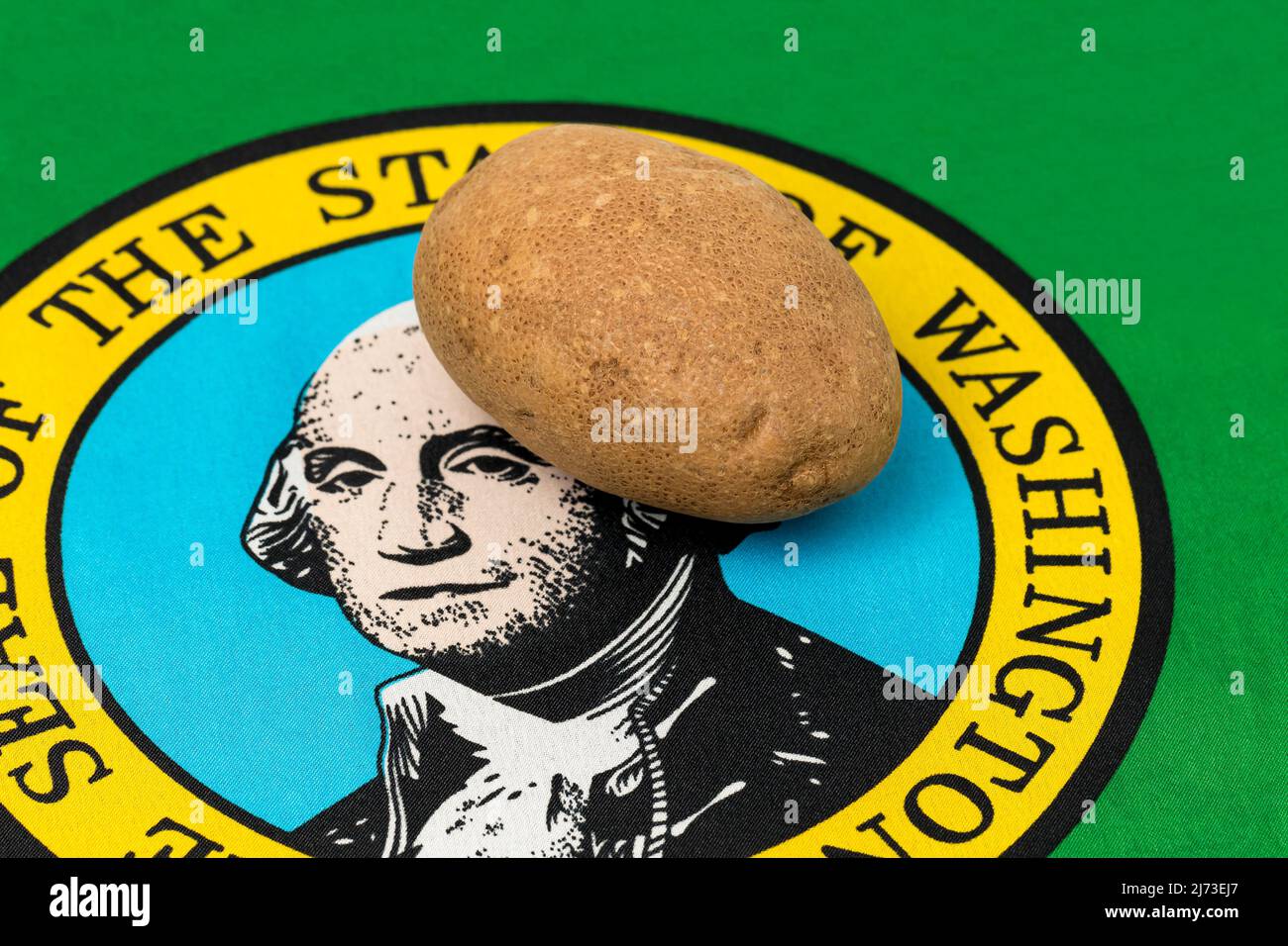 Russet Potato with Washington state flag. Potato farming production, trade and exports concept. Stock Photo