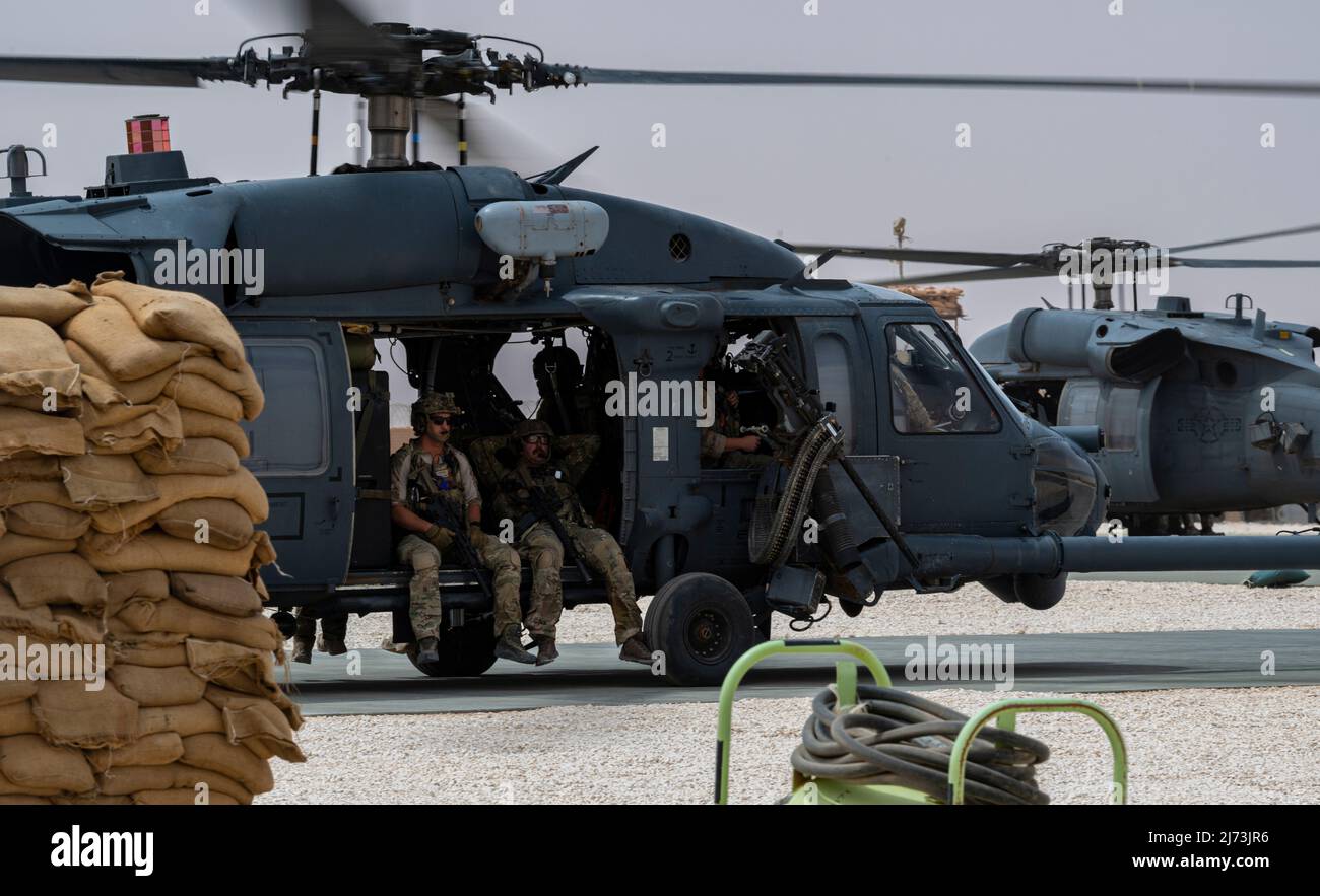 U.S. Air Force Pararescuemen, assigned to the 52nd Expeditionary Rescue Squadron, prepare to take off in an HH-60 Pave Hawk, assigned to the 46th ERQSs, for a combat search and rescue exercise at an undisclosed location, April 28, 2022. Air Forces Central Command's ERQSs are organized, trained, equipped, and postured to conduct full spectrum personnel recovery to include both conventional and unconventional combat rescue operations within the Central Command theater of operations. (U.S. Air Force photo by Staff Sgt. Christian Sullivan) Stock Photo