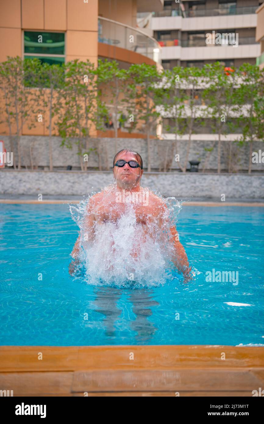 sports guy jumping in the big pool Stock Photo