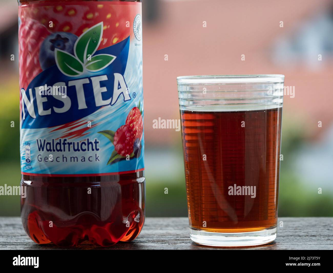 A view of a glass and plastic bottle of Nestea Wild Berries Stock Photo